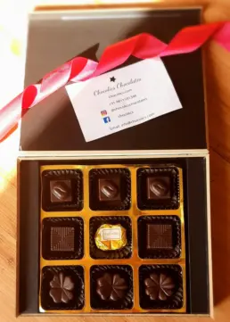 Corporate Chocolate Gifting in 2025: The Sweetest Way to Impress Clients 1 Corporate chocolate gift box with logo branding and gold wrap