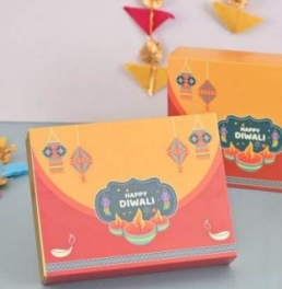 Elegant Diwali hamper box with nuts, cookies, chocolates, date bites, candle & personalized card in festive packaging