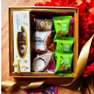 Elegant golden Diwali hamper box with nuts, cookies, chocolates, date bites, candle & personalized festive card