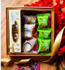 Elegant golden Diwali hamper box with nuts, cookies, chocolates, date bites, candle & personalized festive card