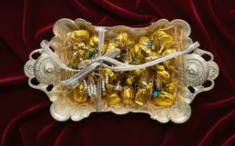 Elegant silver tray gift hamper filled with golden-wrapped assorted Chocolics chocolates arranged neatly with a decorative ribbon